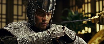 Movie still from “Curse of the Golden Flower” (2006), directed by Yimou Zhang – A person holding a sword; Close Up shot, Over the shoulder angle