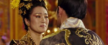 Movie still from “Curse of the Golden Flower” (2006), directed by Yimou Zhang – A person wearing a costume; Close Up shot, Over the shoulder angle