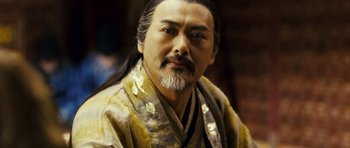 Movie still from “Curse of the Golden Flower” (2006), directed by Yimou Zhang – A person wearing a robe; Close Up shot, Over the shoulder angle