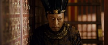 Movie still from “Curse of the Golden Flower” (2006), directed by Yimou Zhang – A man wearing a black and gold headpiece; Close Up shot, Low angle
