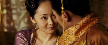 Movie still from “Curse of the Golden Flower” (2006), directed by Yimou Zhang – A young asian man kissing a young asian woman's forehead; Close Up shot, Over the shoulder angle