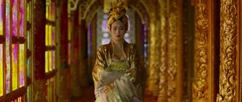 Movie still from “Curse of the Golden Flower” (2006), directed by Yimou Zhang – A woman wearing a gold dress and a yellow headpiece; Medium shot, Over the shoulder angle