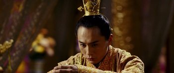 Movie still from “Curse of the Golden Flower” (2006), directed by Yimou Zhang – A man with a gold crown on his head looking down; Close Up shot, Low angle
