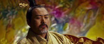 Movie still from “Curse of the Golden Flower” (2006), directed by Yimou Zhang – A man with a beard and a long mustache; Close Up shot, Low angle