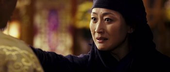 Movie still from “Curse of the Golden Flower” (2006), directed by Yimou Zhang – A person wearing a hat; Close Up shot, Over the shoulder angle