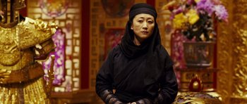 Movie still from “Curse of the Golden Flower” (2006), directed by Yimou Zhang – A woman wearing a black headscarf and a black robe; Close Up shot, Low angle