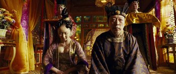 Movie still from “Curse of the Golden Flower” (2006), directed by Yimou Zhang – A couple of people that are dressed up; Medium shot, Low angle