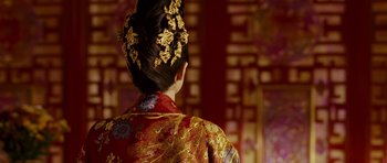 Movie still from “Curse of the Golden Flower” (2006), directed by Yimou Zhang – A woman in a red and gold dress; Close Up shot, Over the shoulder angle