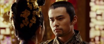 Movie still from “Curse of the Golden Flower” (2006), directed by Yimou Zhang – A person wearing a crown; Close Up shot, Over the shoulder angle