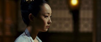 Movie still from “Curse of the Golden Flower” (2006), directed by Yimou Zhang – A young woman with long black hair wearing a white shirt; Close Up shot, Over the shoulder angle
