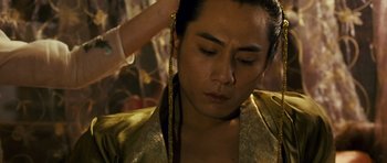 Movie still from “Curse of the Golden Flower” (2006), directed by Yimou Zhang – A person with a gold necklace; Close Up shot, High angle