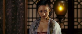 Movie still from “Curse of the Golden Flower” (2006), directed by Yimou Zhang – A young woman in oriental dress looking at the camera; Close Up shot, Over the shoulder angle