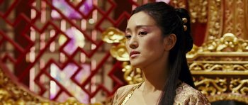 Movie still from “Curse of the Golden Flower” (2006), directed by Yimou Zhang – A woman in a gold dress looking to her left; Close Up shot, Over the shoulder angle