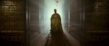 Movie still from “Curse of the Golden Flower” (2006), directed by Yimou Zhang – A person in a gold gown and a crown; Wide shot, Low angle