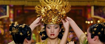 Movie still from “Curse of the Golden Flower” (2006), directed by Yimou Zhang – A woman wearing a gold headdress with gold leaves on it; Close Up shot, Low angle