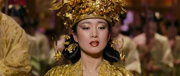 Movie still from “Curse of the Golden Flower” (2006), directed by Yimou Zhang – A woman in a gold dress and a gold headpiece; Close Up shot, Low angle