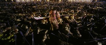 Movie still from “Curse of the Golden Flower” (2006), directed by Yimou Zhang – A woman is standing in the middle of a lot of garbage; Extreme Wide shot, High angle