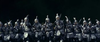 Movie still from “Curse of the Golden Flower” (2006), directed by Yimou Zhang – A group of men in armor holding swords and wearing helmets; Wide shot, Low angle
