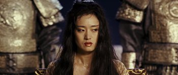 Movie still from “Curse of the Golden Flower” (2006), directed by Yimou Zhang – A person with long black hair; Close Up shot, Over the shoulder angle