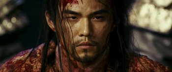 Movie still from “Curse of the Golden Flower” (2006), directed by Yimou Zhang – A person with blood all over his face; Close Up shot, Low angle