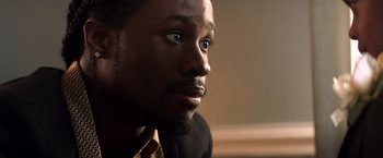 Movie still from “Cut Throat City” (2020), directed by RZA – A person looking at the camera; Close Up shot, Over the shoulder angle