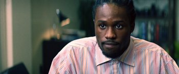 Movie still from “Cut Throat City” (2020), directed by RZA – A person wearing a striped shirt; Close Up shot, High angle