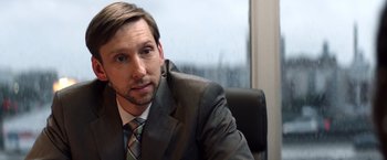 Movie still from “Cut Throat City” (2020), directed by RZA – A person wearing a suit and tie; Close Up shot, Over the shoulder angle