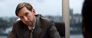 Movie still from “Cut Throat City” (2020), directed by RZA – A person wearing a suit and tie; Close Up shot, Over the shoulder angle