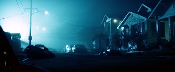 Movie still from “Cut Throat City” (2020), directed by RZA – Cars parked on the side of the road at night in the fog; Extreme Wide shot, Low angle