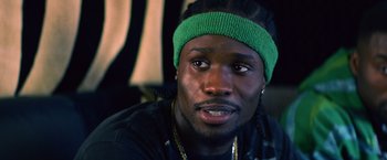 Movie still from “Cut Throat City” (2020), directed by RZA – A person wearing a headband; Close Up shot, Over the shoulder angle