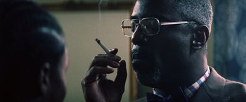 Movie still from “Cut Throat City” (2020), directed by RZA – A person smoking a cigarette; Close Up shot, Low angle