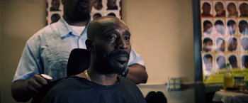 Movie still from “Cut Throat City” (2020), directed by RZA – A bald man sitting in front of a mirror; Close Up shot, Over the shoulder angle