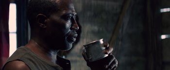 Movie still from “Cut Throat City” (2020), directed by RZA – A person holding a cup of coffee; Close Up shot, Low angle