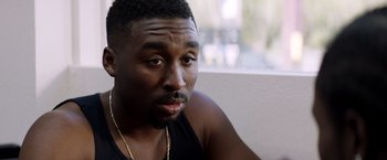 Movie still from “Cut Throat City” (2020), directed by RZA – A person wearing a black shirt; Close Up shot, Over the shoulder angle