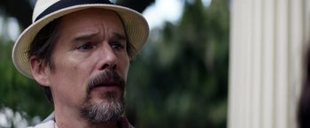 Movie still from “Cut Throat City” (2020), directed by RZA – A person wearing a hat; Close Up shot, Over the shoulder angle