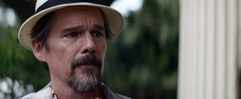 Movie still from “Cut Throat City” (2020), directed by RZA – A person wearing a hat; Close Up shot, Over the shoulder angle