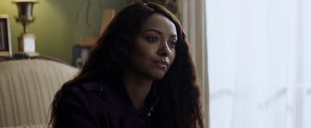 Movie still from “Cut Throat City” (2020), directed by RZA – A person with long brown hair; Close Up shot, Over the shoulder angle