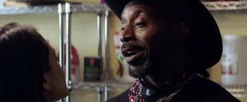 Movie still from “Cut Throat City” (2020), directed by RZA – A person wearing a cowboy hat; Close Up shot, Low angle