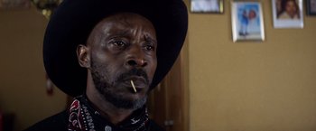 Movie still from “Cut Throat City” (2020), directed by RZA – A person wearing a cowboy hat; Close Up shot, Low angle