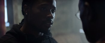 Movie still from “Cut Throat City” (2020), directed by RZA – A man's face in the dark; Close Up shot, Low angle