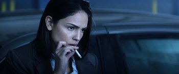 Movie still from “Cut Throat City” (2020), directed by RZA – A woman smoking a cigarette while sitting in a car; Close Up shot, Over the shoulder angle