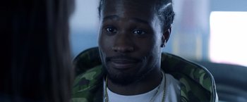 Movie still from “Cut Throat City” (2020), directed by RZA – A person wearing a white shirt; Close Up shot, Over the shoulder angle