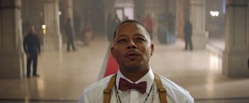 Movie still from “Cut Throat City” (2020), directed by RZA – A person wearing a bow tie and suspenders; Close Up shot, Low angle