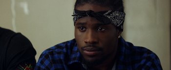 Movie still from “Cut Throat City” (2020), directed by RZA – A person wearing a head band; Close Up shot, Over the shoulder angle