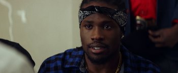 Movie still from “Cut Throat City” (2020), directed by RZA – A person wearing a head band; Close Up shot, Over the shoulder angle