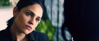 Movie still from “Cut Throat City” (2020), directed by RZA – A person wearing a suit and tie; Close Up shot, Over the shoulder angle