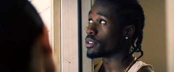 Movie still from “Cut Throat City” (2020), directed by RZA – A person looking out of a window; Close Up shot, Over the shoulder angle