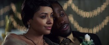 Movie still from “Cut Throat City” (2020), directed by RZA – A man and a woman posing for a picture; Close Up shot, Over the shoulder angle