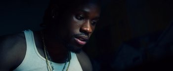 Movie still from “Cut Throat City” (2020), directed by RZA – A person wearing a white shirt; Close Up shot, Low angle