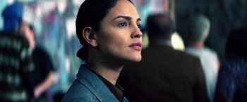 Movie still from “Cut Throat City” (2020), directed by RZA – A person wearing a jean jacket; Close Up shot, Over the shoulder angle